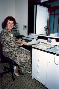 The very first Morrinsville Community House coordinator, Georgina Thomas smiling up from her desk